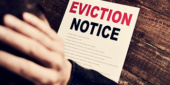 Tenant Evictions: Image of tenant holding an eviction notice.